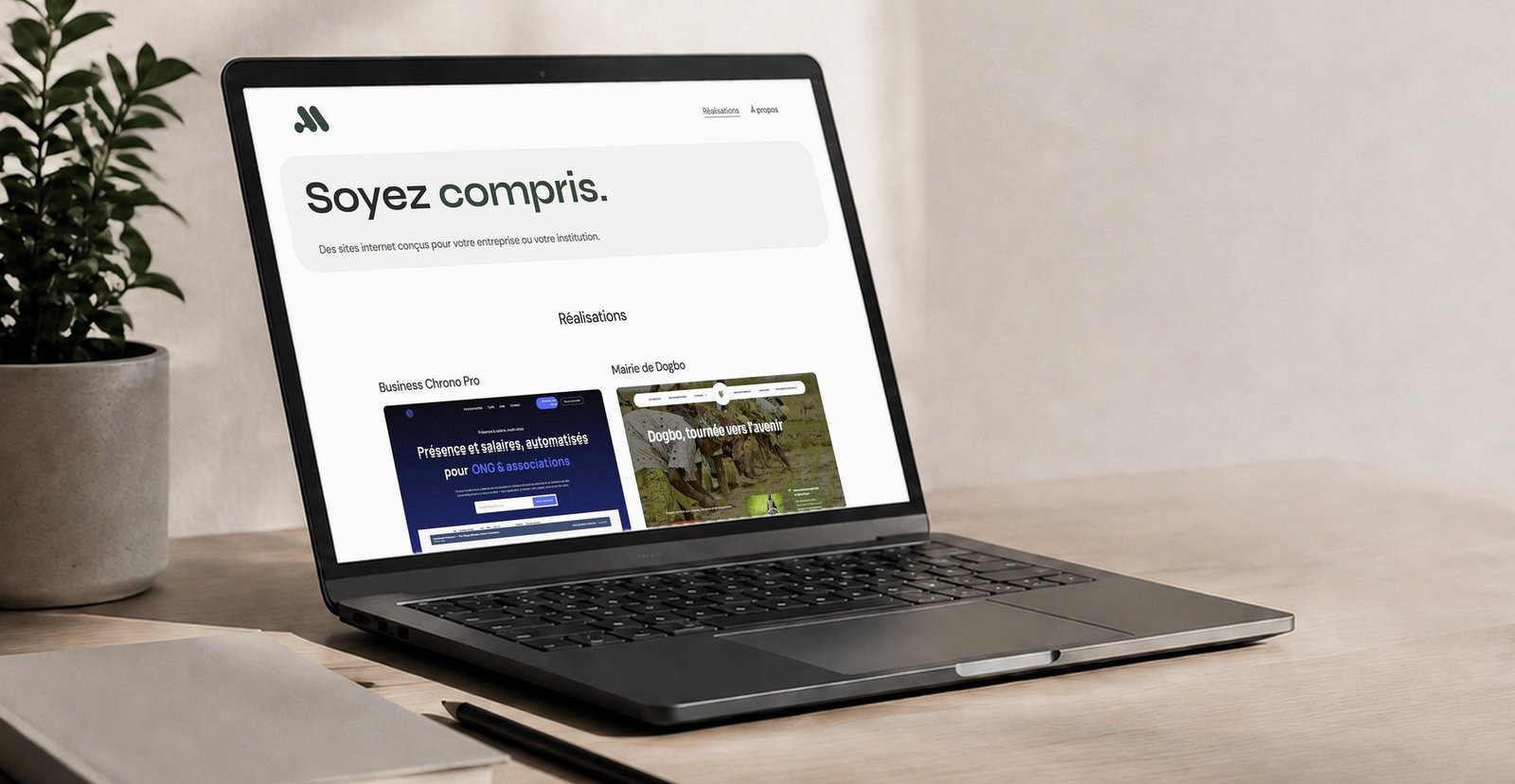 Site internet Alan Creative affiché sur un ordinateur portable, sur un bureau clair